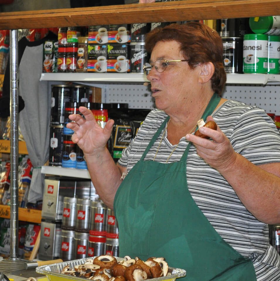 Claro's Cooking class and wearing green apron.