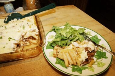 Creamy baked pasta casserole with green salad