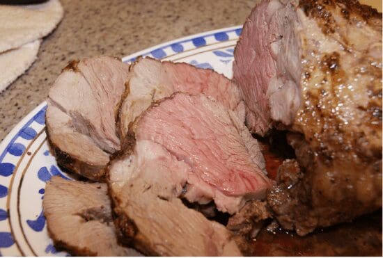 Sliced medium-rare roast beef on plate