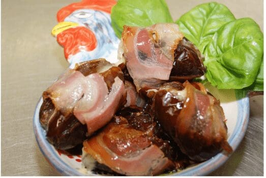 Bacon-wrapped dates with basil garnish