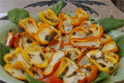 Cheesy stuffed mini bell peppers on greens