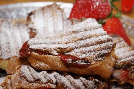 Strawberry-stuffed French toast with powdered sugar