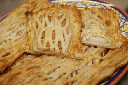 Golden lattice apple pastry turnovers on plate