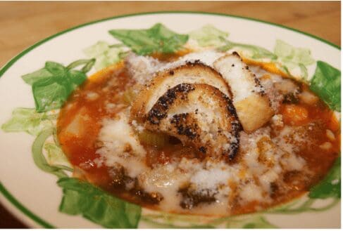 Hearty tomato vegetable soup with cheesy croutons