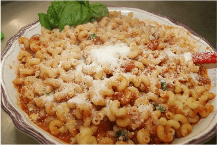 Bowl of macaroni with tomato sauce and cheese