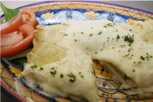 Ravioli in creamy white sauce with tomatoes