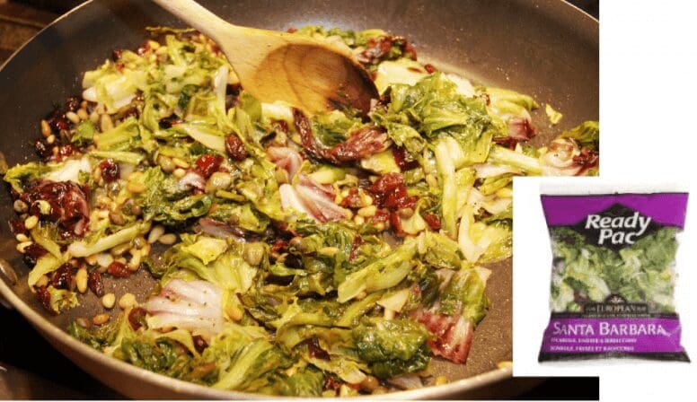 Stir-fried greens with wooden spoon in pan.